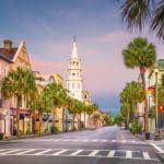 Colorful historic homes and church steeple along Church Street in downtown Charleston, South Carolina — a preserved neighborhood where lead paint may still be present in older homes.