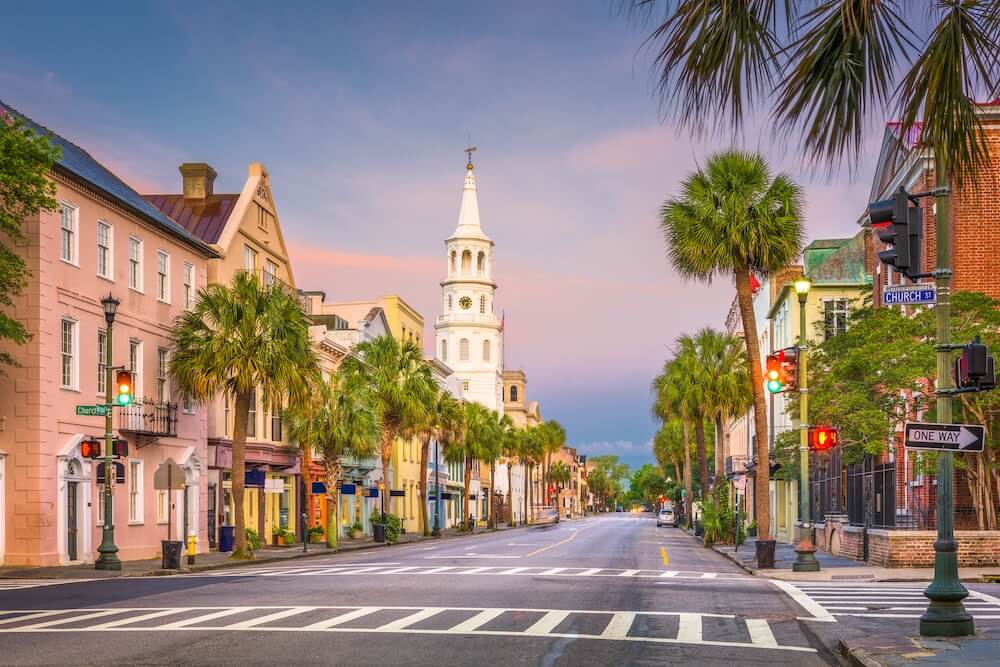 Colorful historic homes and church steeple along Church Street in downtown Charleston, South Carolina — a preserved neighborhood where lead paint may still be present in older homes.